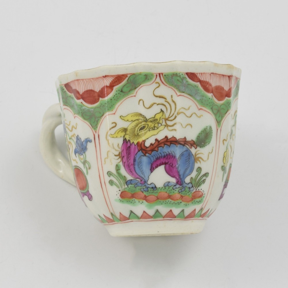 An 18th-century fluted soft-paste porcelain coffee cup with hand-painted Chinoiserie dragon motifs and a looped handle. View IX