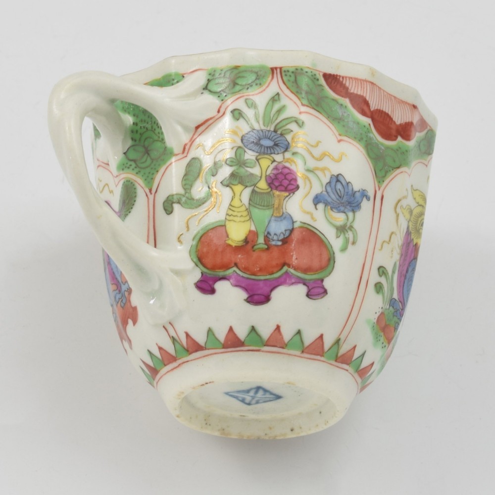 An 18th-century fluted soft-paste porcelain coffee cup with hand-painted Chinoiserie dragon motifs and a looped handle. View XI