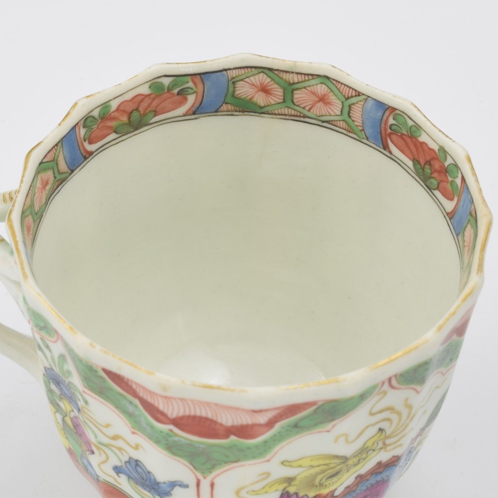 An 18th-century fluted soft-paste porcelain coffee cup with hand-painted Chinoiserie dragon motifs and a looped handle. View XII