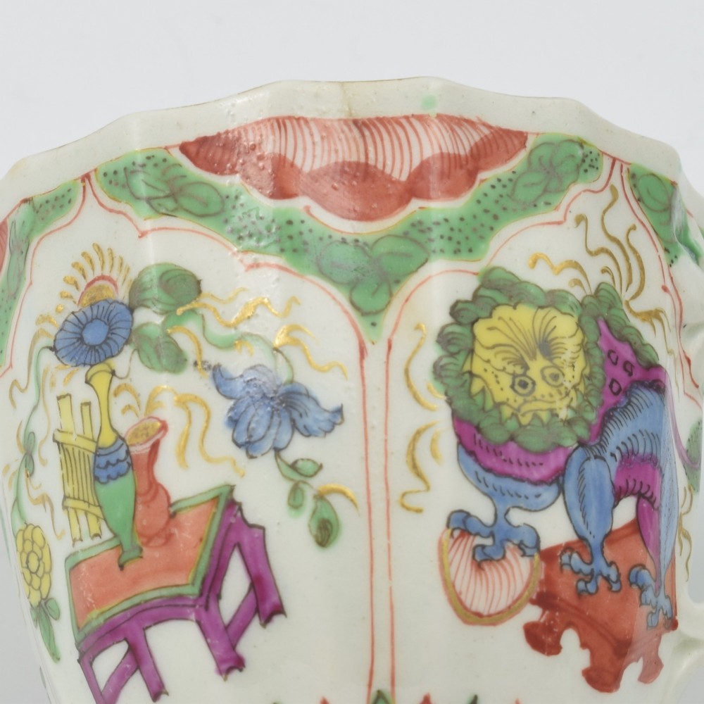 An 18th-century fluted soft-paste porcelain coffee cup with hand-painted Chinoiserie dragon motifs and a looped handle. View XIII