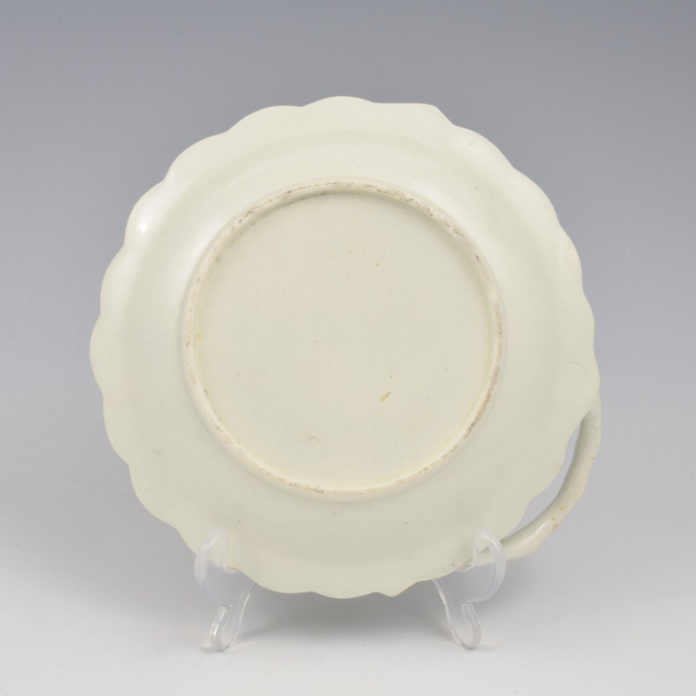 An 18th-century Worcester soft-paste porcelain sweetmeat dish featuring relief-moulded rose leaves, a branch handle, multi-coloured hand-painted floral sprays, and a gilded rim. View VII