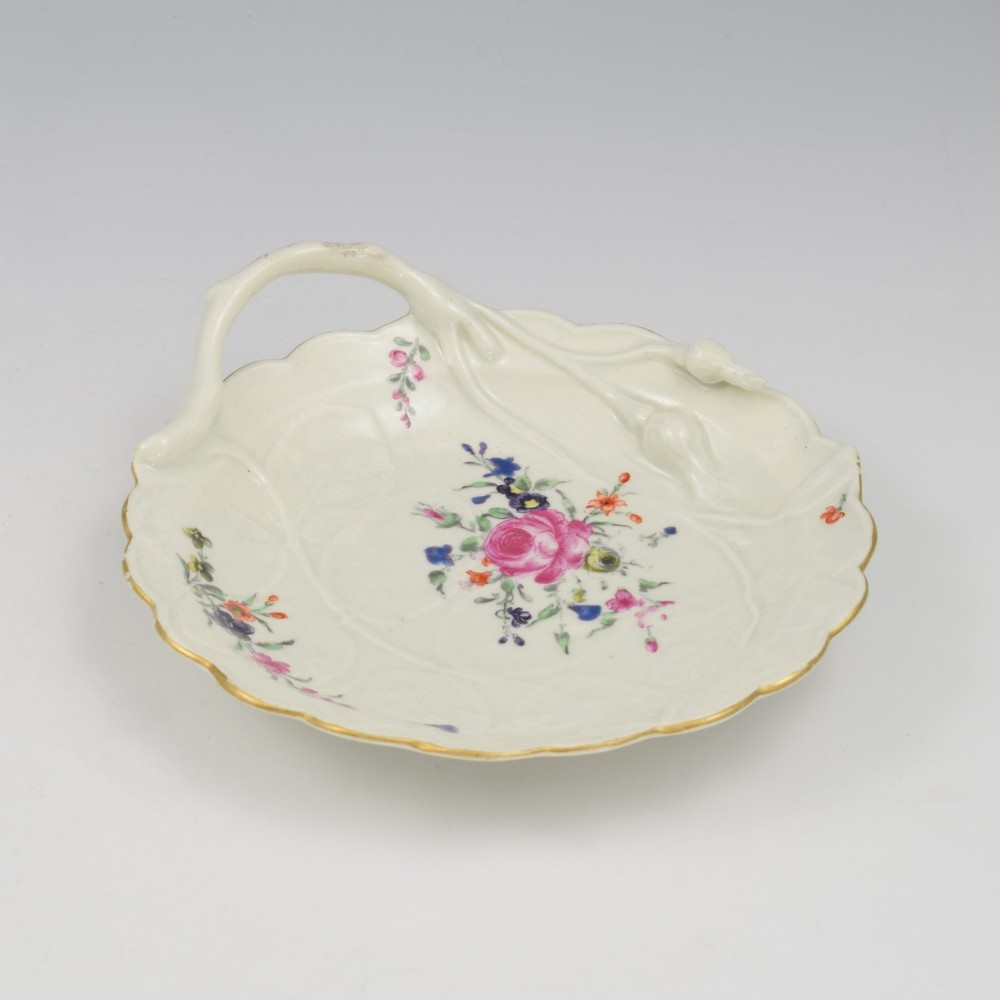 An 18th-century Worcester soft-paste porcelain sweetmeat dish featuring relief-moulded rose leaves, a branch handle, multi-coloured hand-painted floral sprays, and a gilded rim. View IX