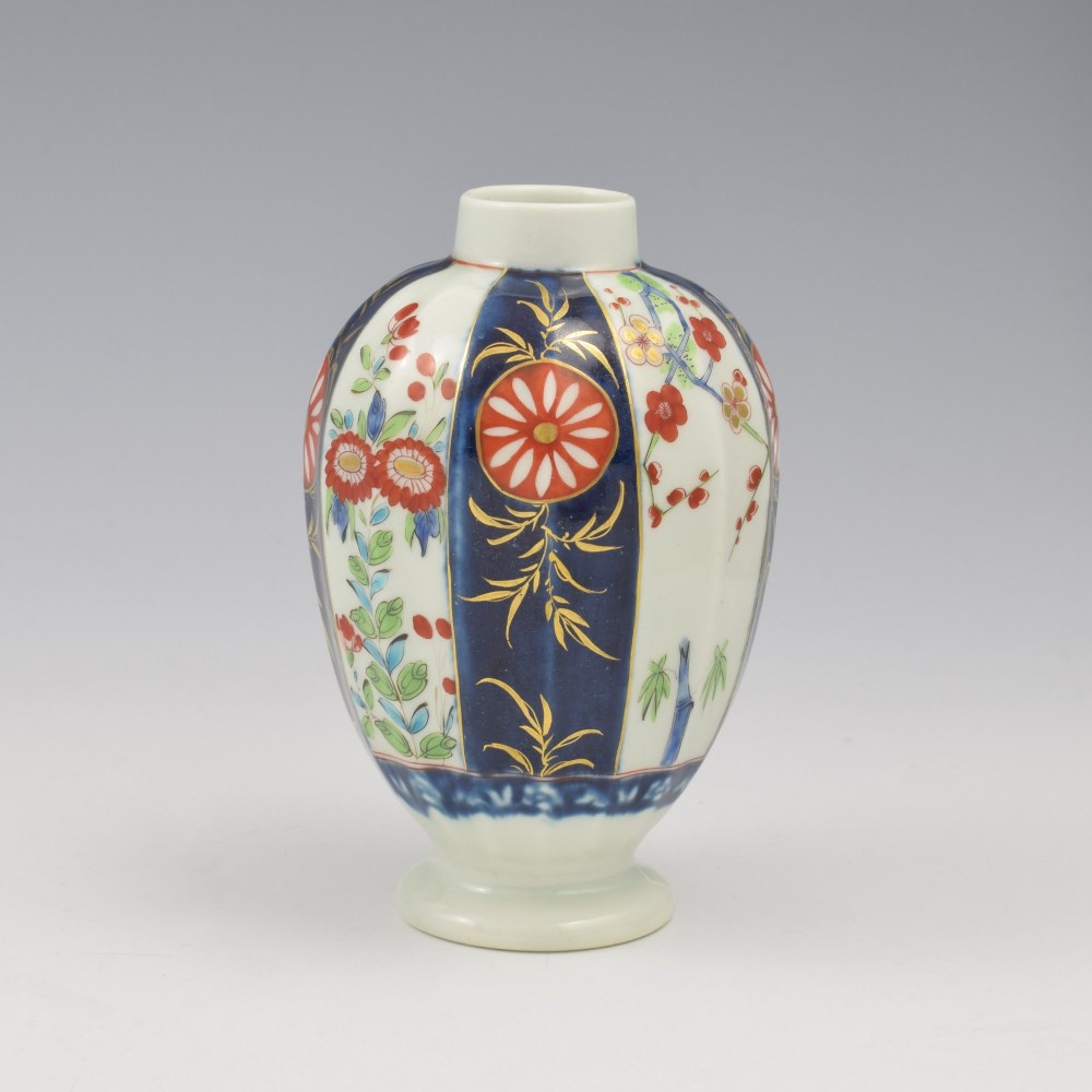 A First Period Worcester soft-paste porcelain tea canister decorated with cobalt blue panels, gilt scrolls, and polychrome floral reserves. View VII