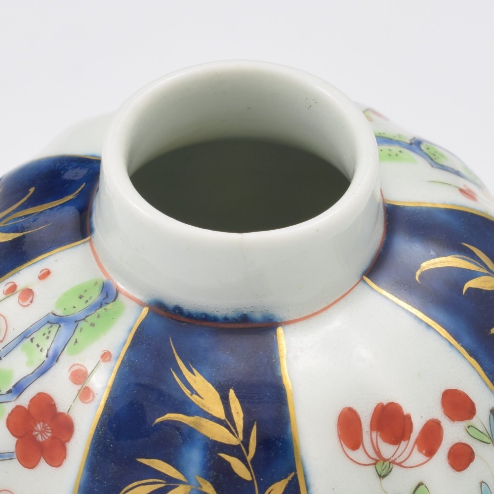 A First Period Worcester soft-paste porcelain tea canister decorated with cobalt blue panels, gilt scrolls, and polychrome floral reserves. View XIII