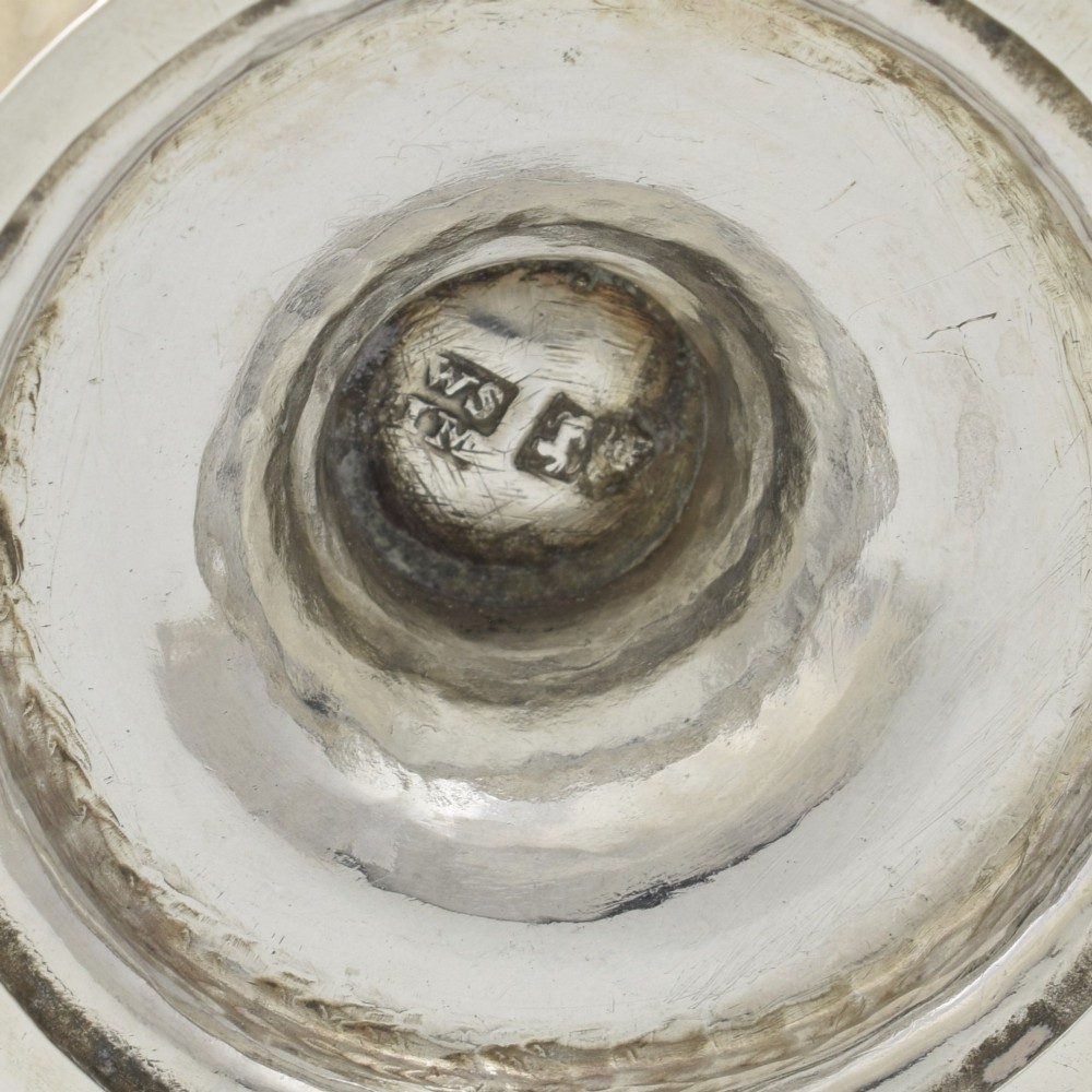 A Georgian sterling silver milk jug featuring a baluster body, pedestal foot, beaded rim, and double-scroll handle. View XII