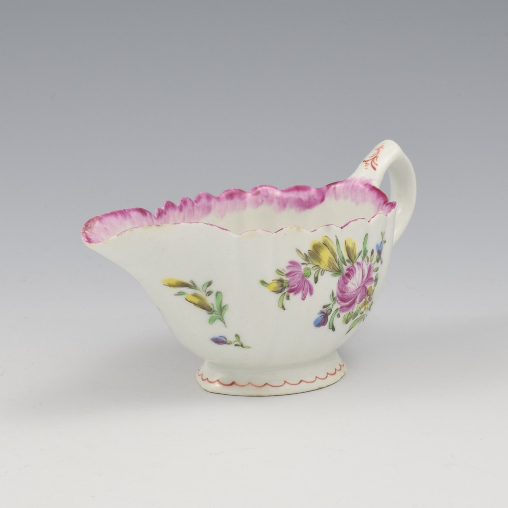 An eighteenth-century Bow soft-paste porcelain fluted sauce boat with hand-painted floral sprigs and a magenta feathered rim. View III
