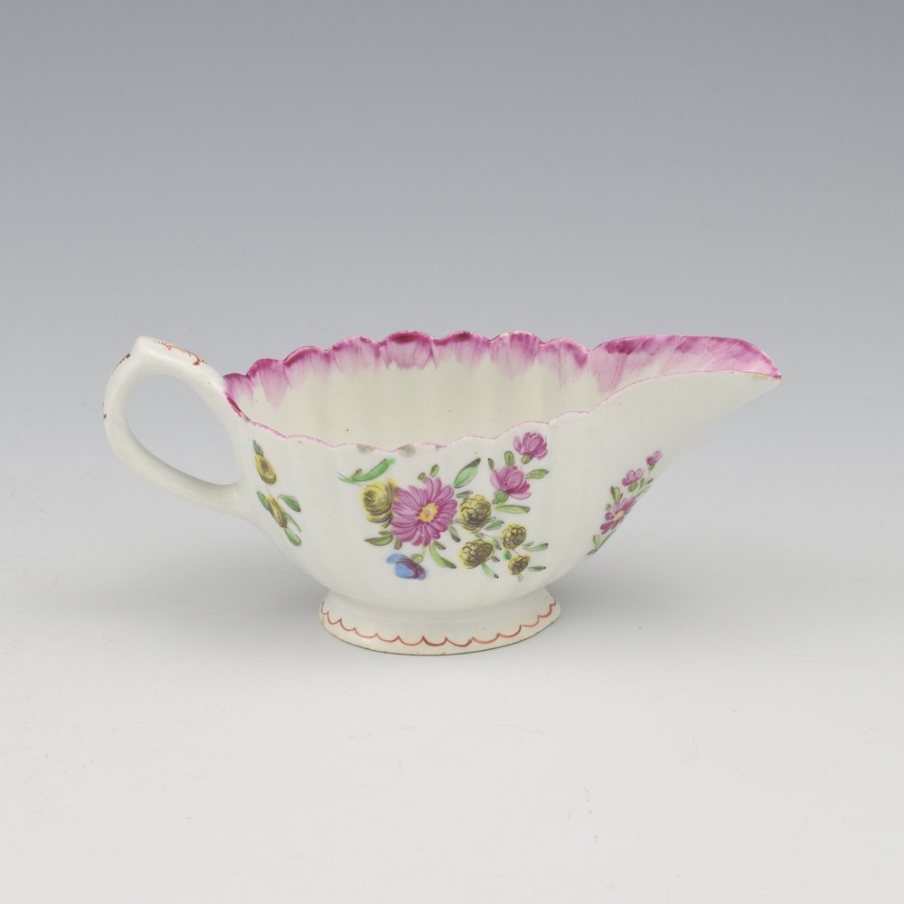 An eighteenth-century Bow soft-paste porcelain fluted sauce boat with hand-painted floral sprigs and a magenta feathered rim. View VII