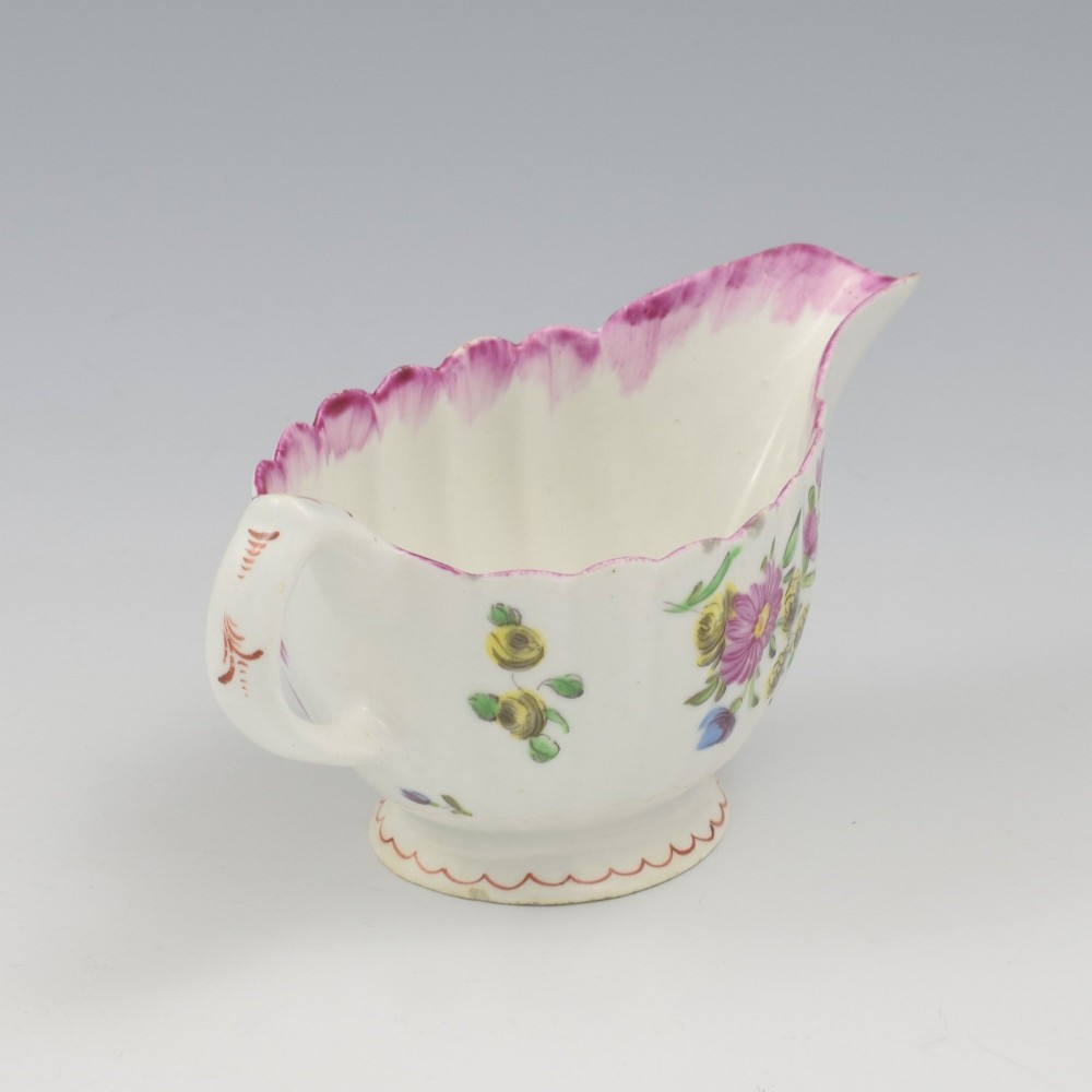 An eighteenth-century Bow soft-paste porcelain fluted sauce boat with hand-painted floral sprigs and a magenta feathered rim. View VIII