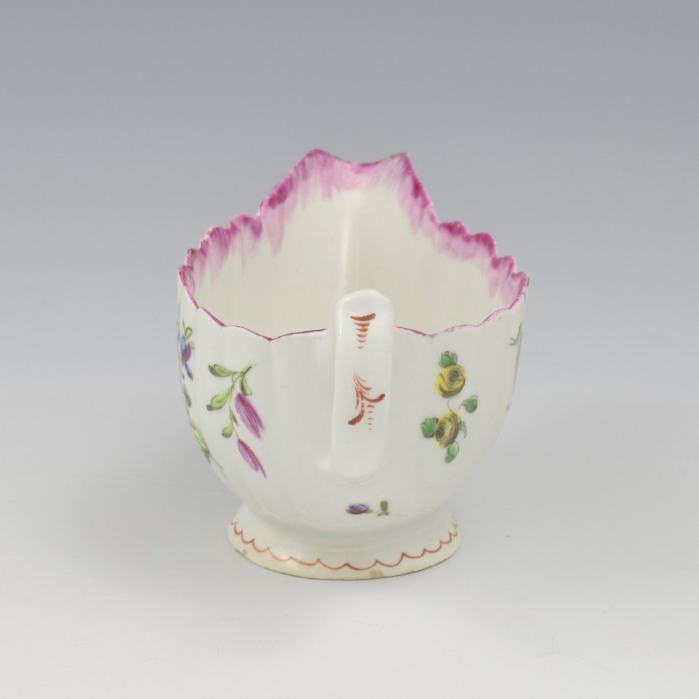 An eighteenth-century Bow soft-paste porcelain fluted sauce boat with hand-painted floral sprigs and a magenta feathered rim. View IX