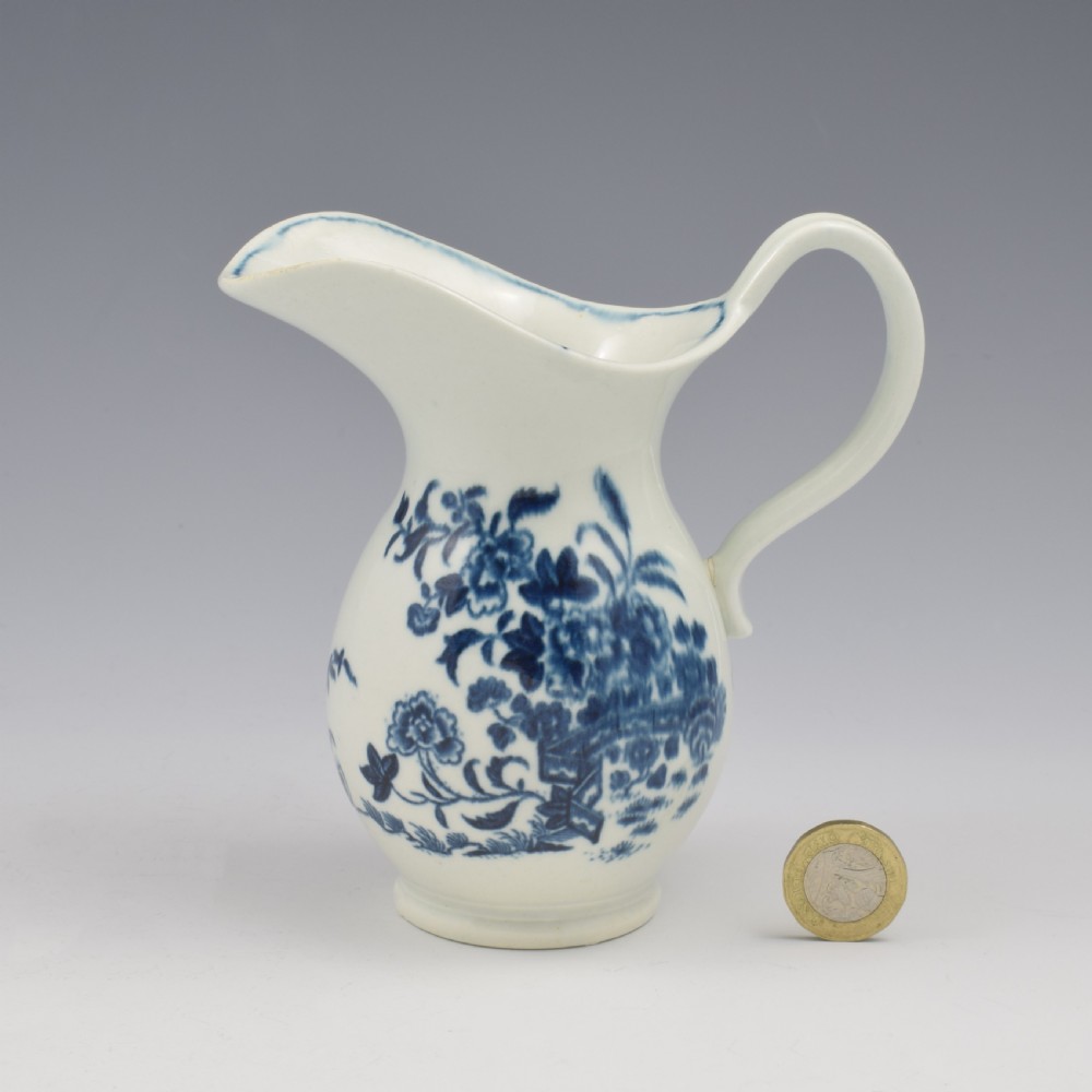 An 18th-century blue and white Worcester porcelain milk ewer featuring a flared spout, loop handle, and hand-painted floral motifs. View II