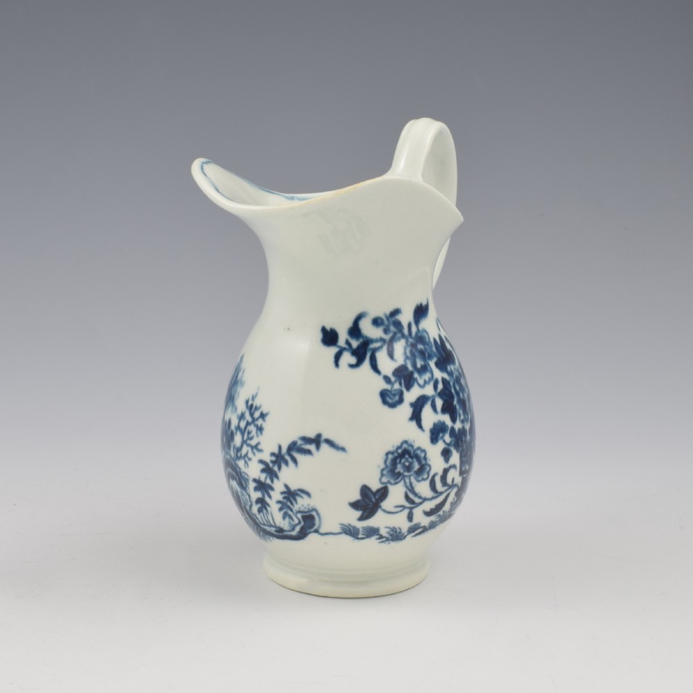 An 18th-century blue and white Worcester porcelain milk ewer featuring a flared spout, loop handle, and hand-painted floral motifs. View III