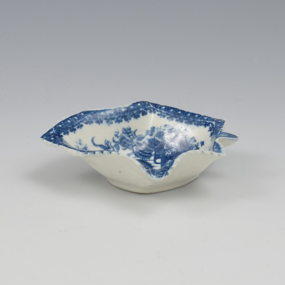 An 18th-century blue and white Caughley soft-paste porcelain pickle dish shaped like a leaf with a serrated rim and printed with a Oriental landscape pattern. View III