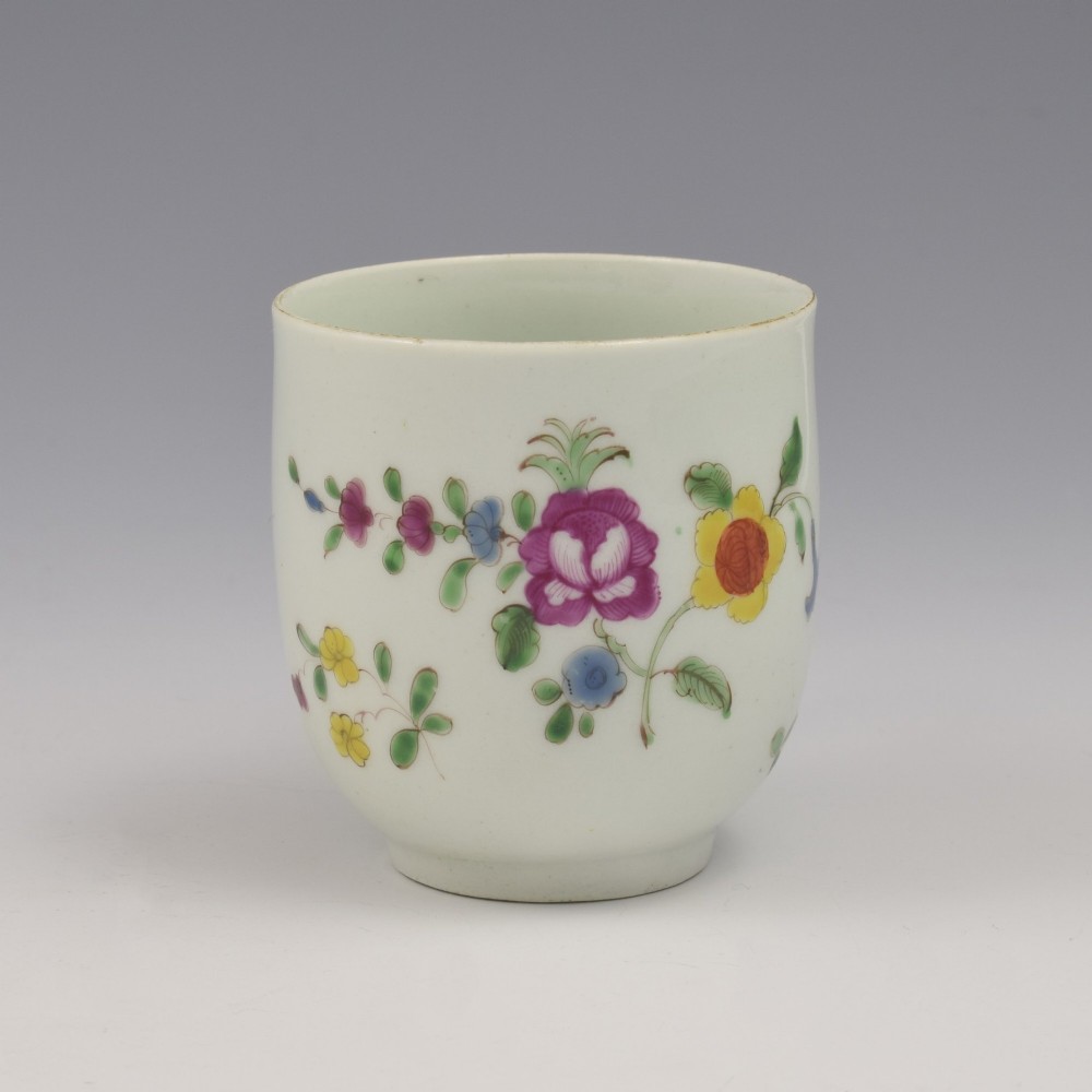 An 18th-century white porcelain coffee cup painted with polychrome floral sprays and featuring a single loop handle. View III