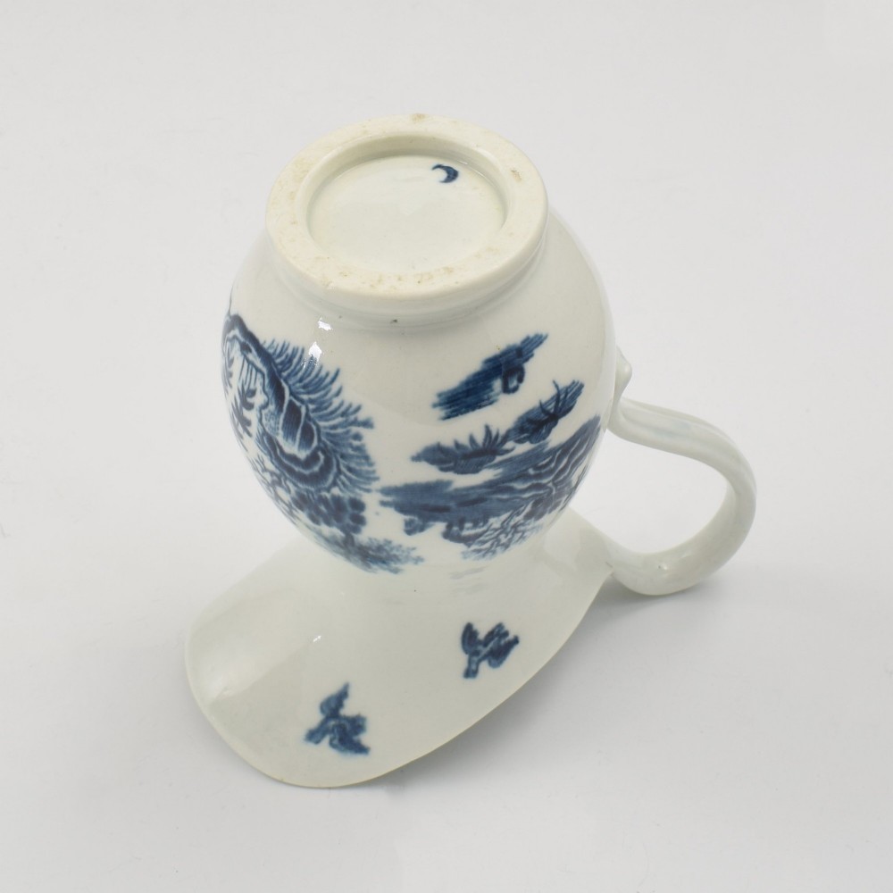 An 18th-century blue and white Worcester porcelain milk ewer featuring a flared spout, loop handle, and hand-painted floral motifs. View XII