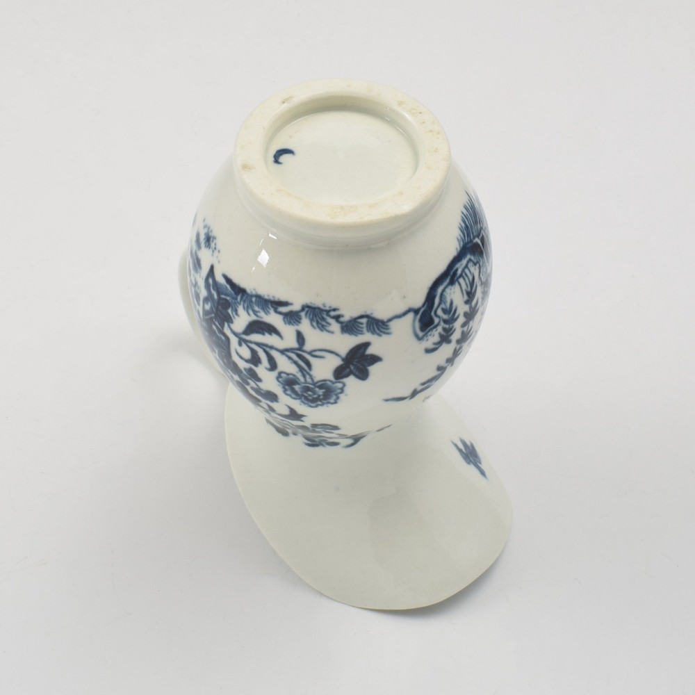 An 18th-century blue and white Worcester porcelain milk ewer featuring a flared spout, loop handle, and hand-painted floral motifs. View XIII