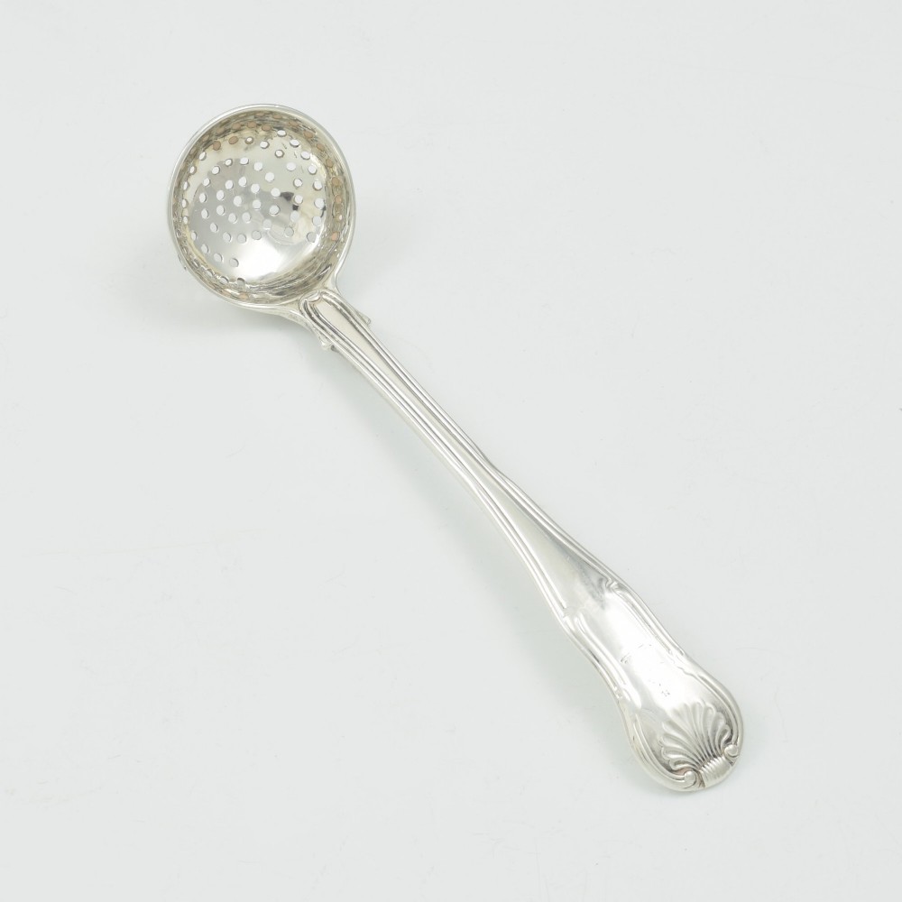 A Georgian sterling silver sifter spoon featuring a circular pierced bowl and a Kings Hourglass pattern handle.