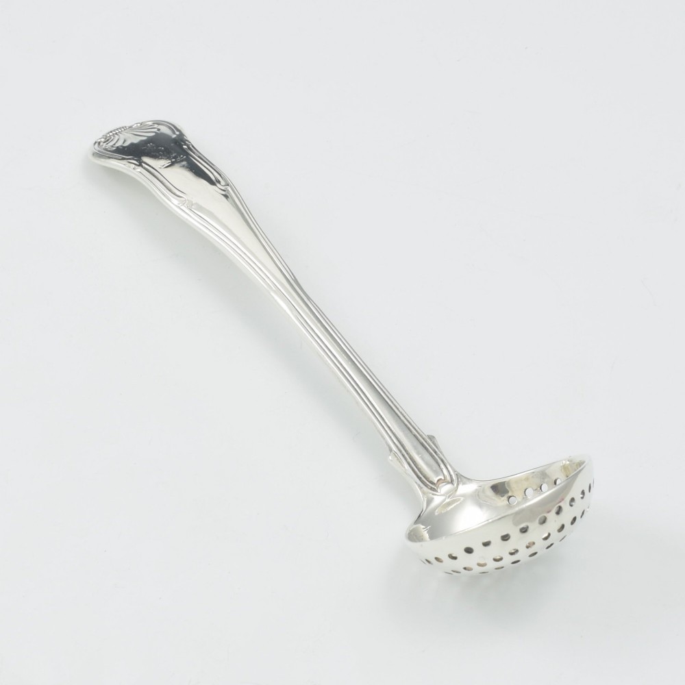 A Georgian sterling silver sifter spoon featuring a circular pierced bowl and a Kings Hourglass pattern handle. View III