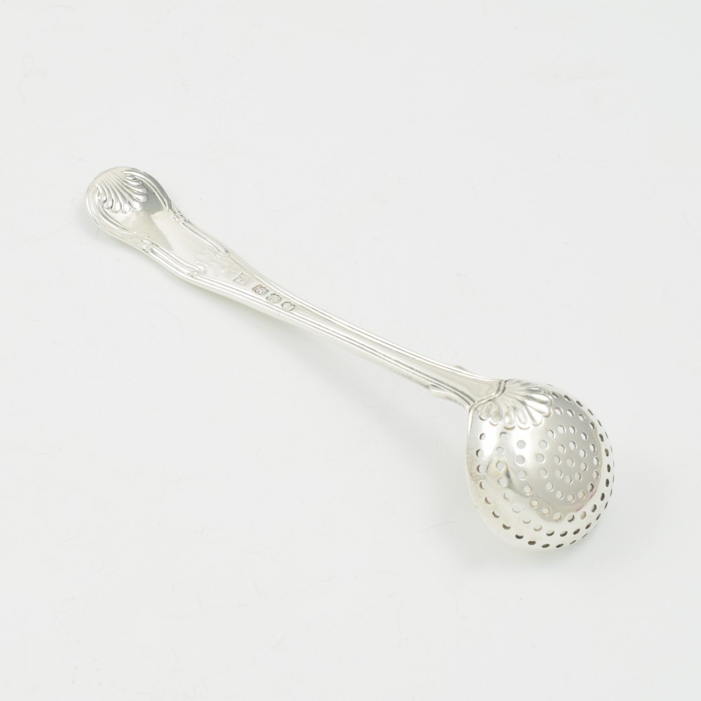 A Georgian sterling silver sifter spoon featuring a circular pierced bowl and a Kings Hourglass pattern handle. View IV