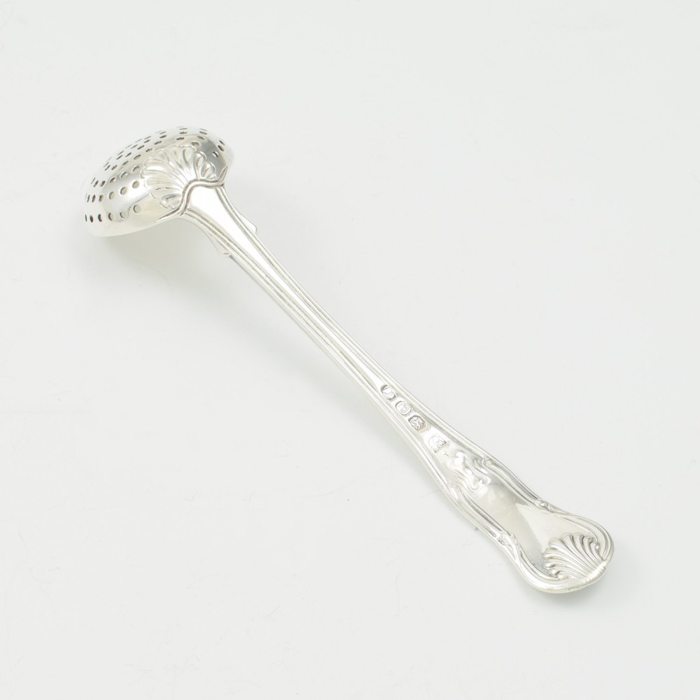 A Georgian sterling silver sifter spoon featuring a circular pierced bowl and a Kings Hourglass pattern handle. View V
