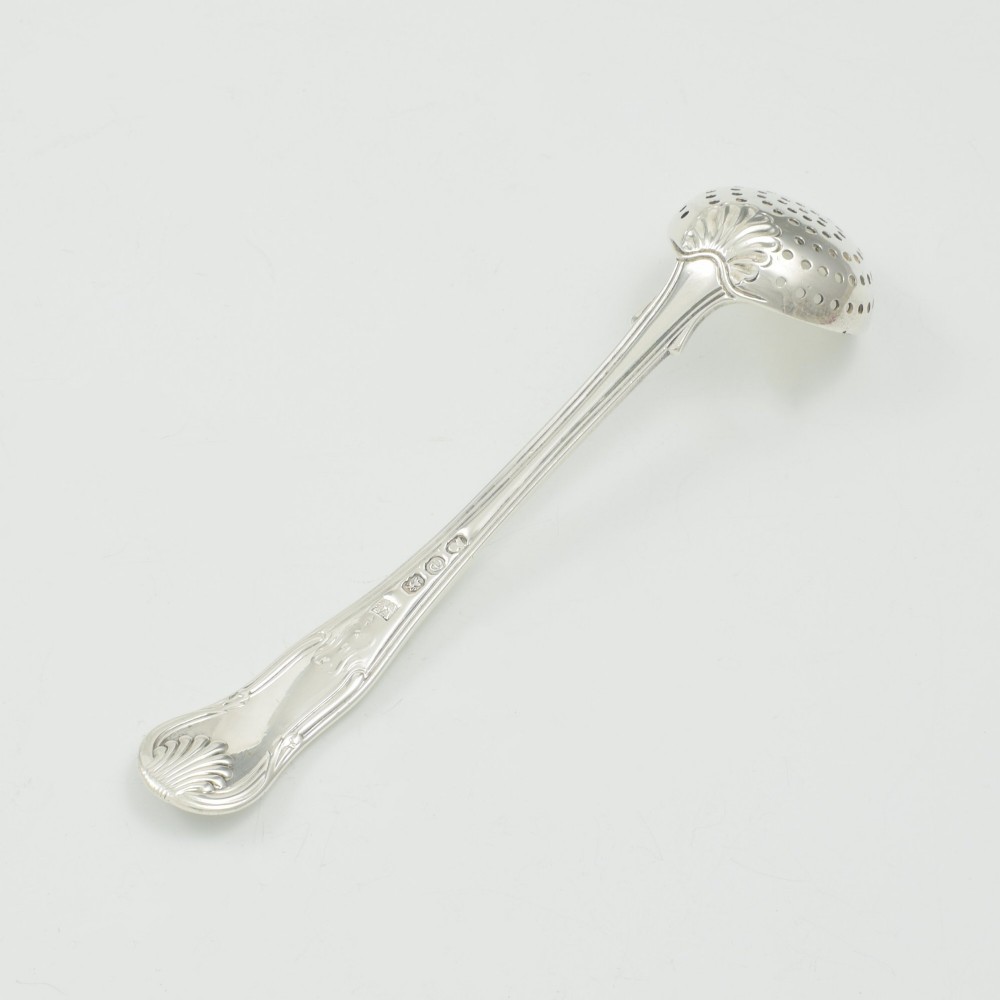 A Georgian sterling silver sifter spoon featuring a circular pierced bowl and a Kings Hourglass pattern handle. View VI