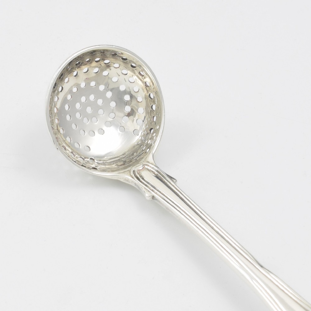 A Georgian sterling silver sifter spoon featuring a circular pierced bowl and a Kings Hourglass pattern handle. View VII