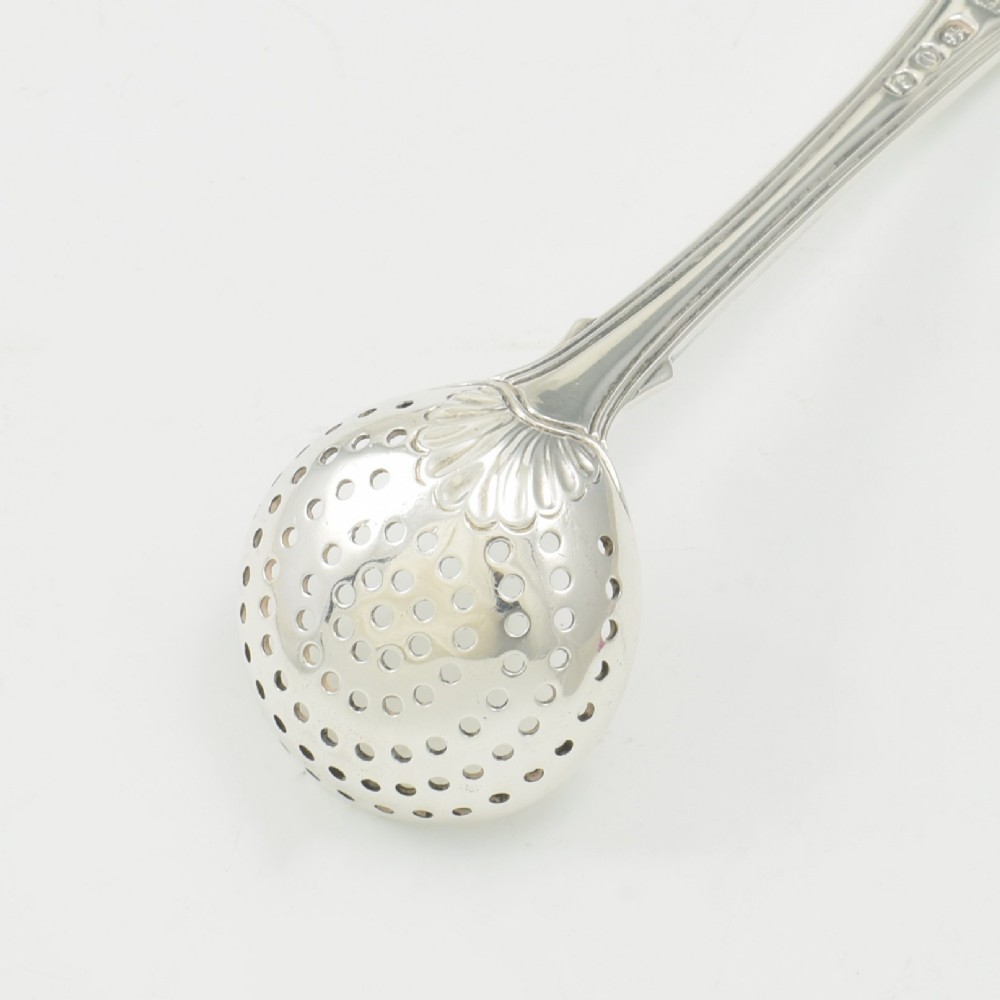 A Georgian sterling silver sifter spoon featuring a circular pierced bowl and a Kings Hourglass pattern handle. View VIII