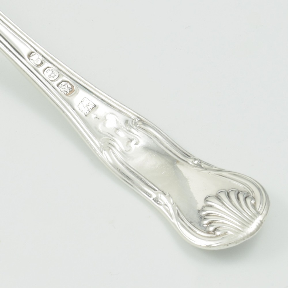 A Georgian sterling silver sifter spoon featuring a circular pierced bowl and a Kings Hourglass pattern handle. View IX
