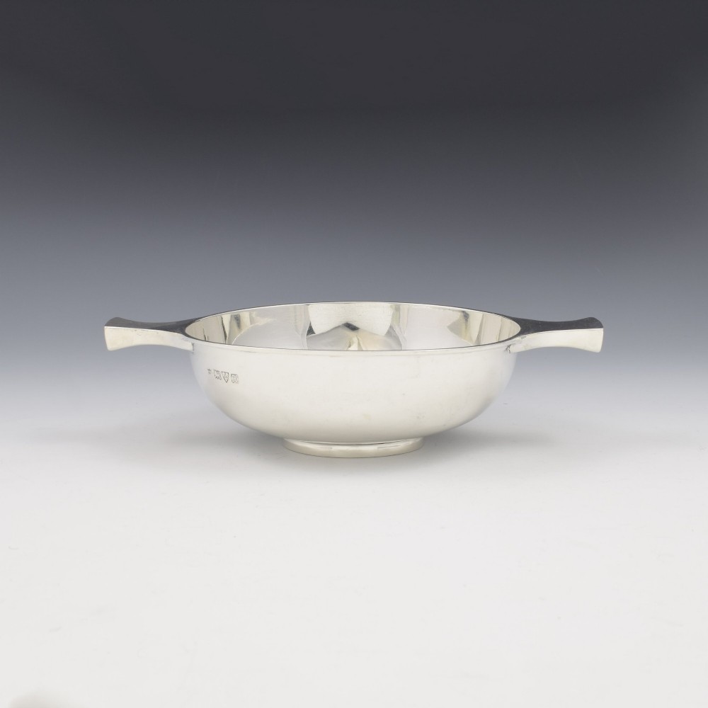 A circular Edwardian sterling silver quaich with a plain polished interior and two flat side handles. View III