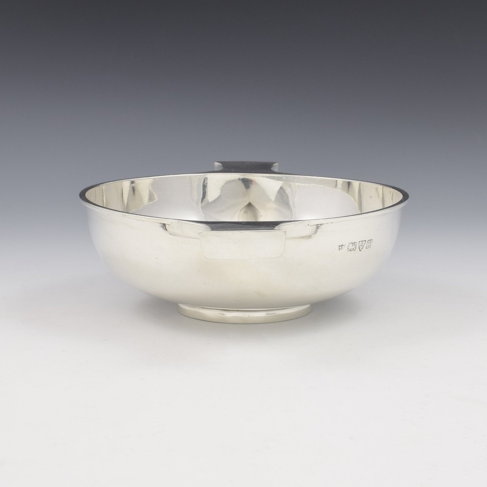 A circular Edwardian sterling silver quaich with a plain polished interior and two flat side handles. View IV