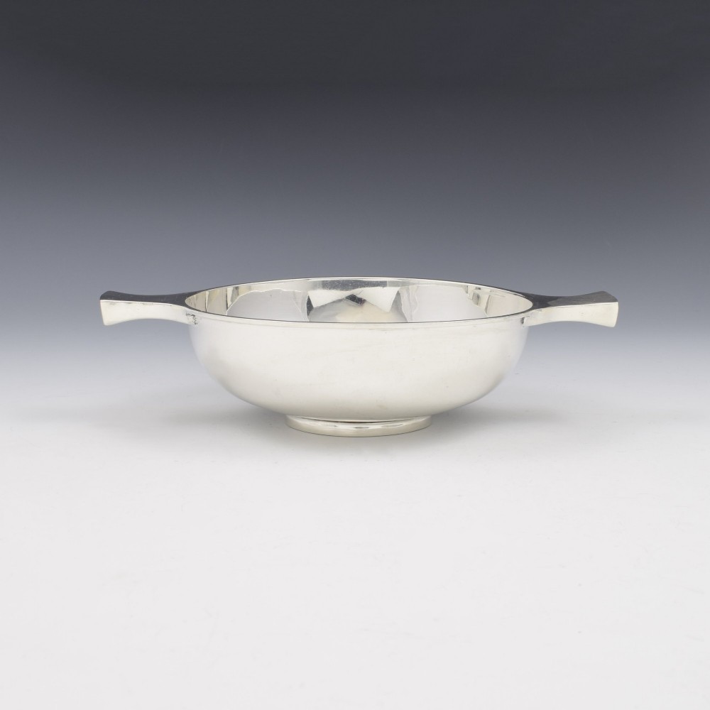 A circular Edwardian sterling silver quaich with a plain polished interior and two flat side handles. View V