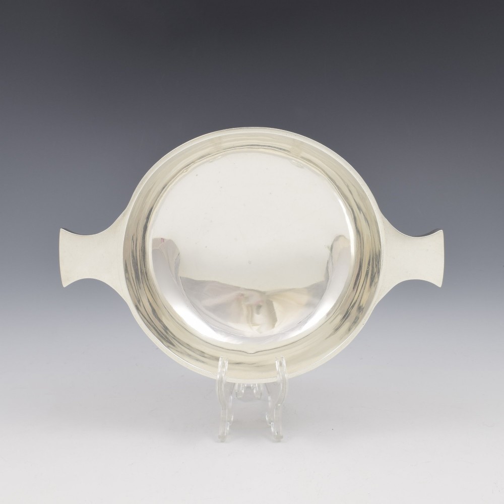 A circular Edwardian sterling silver quaich with a plain polished interior and two flat side handles. View VII