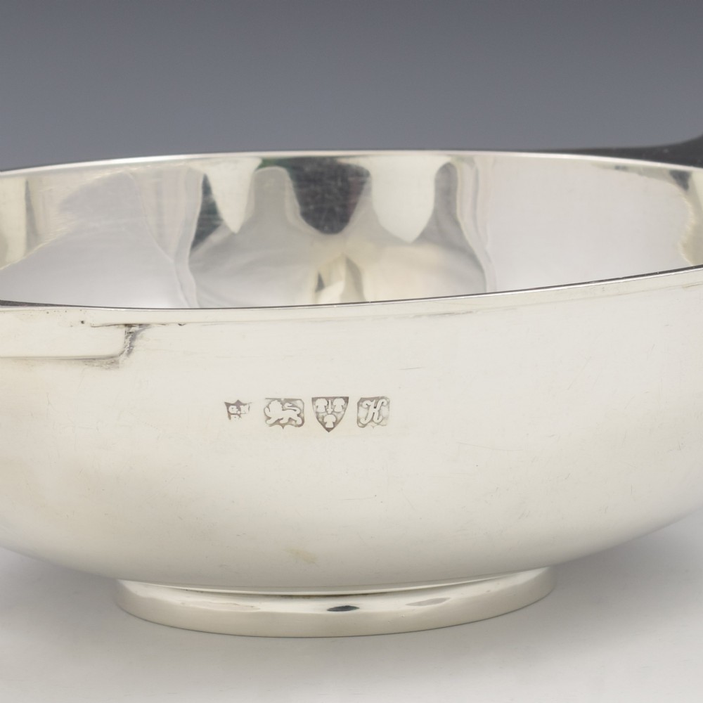 A circular Edwardian sterling silver quaich with a plain polished interior and two flat side handles. View VIII