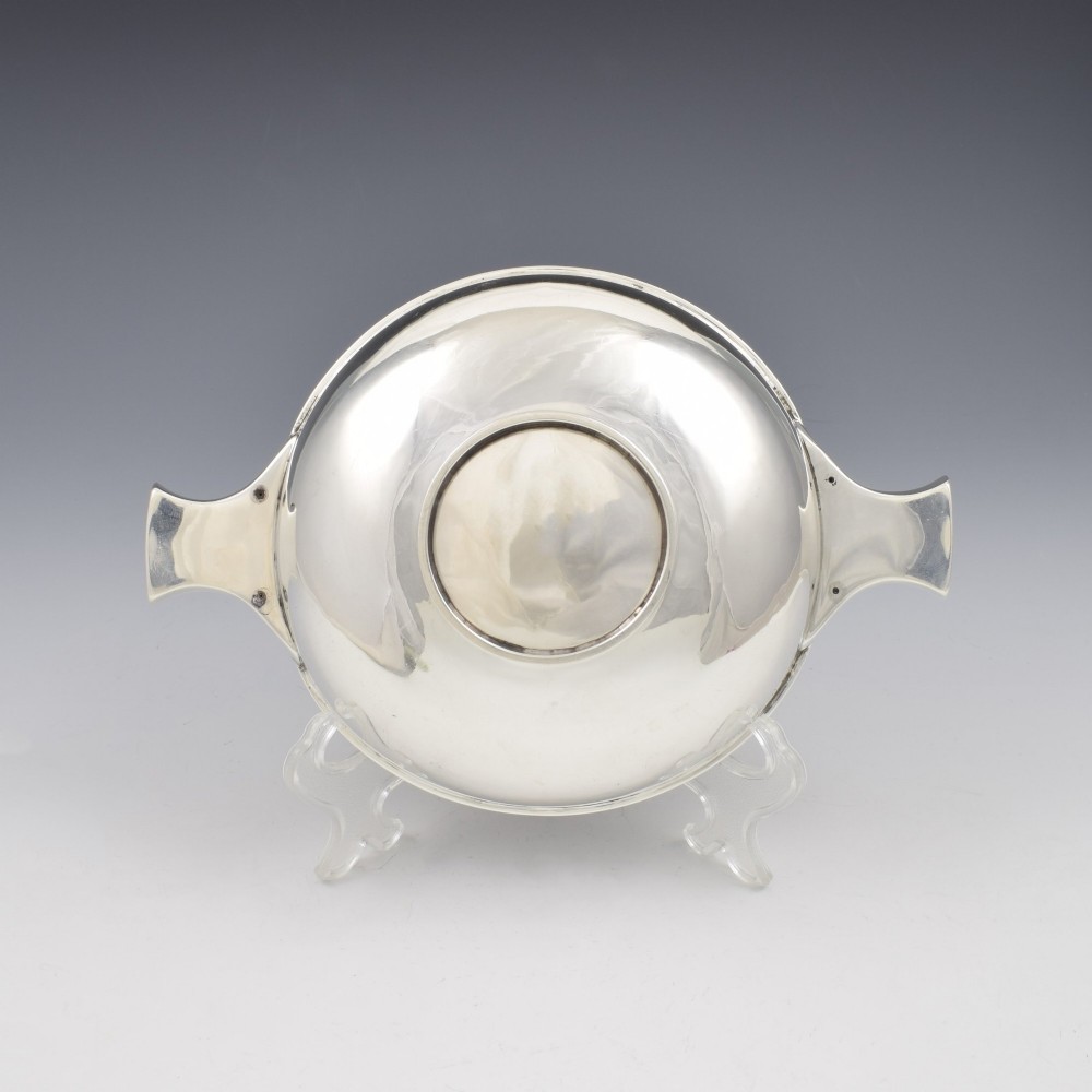 A circular Edwardian sterling silver quaich with a plain polished interior and two flat side handles. View IX