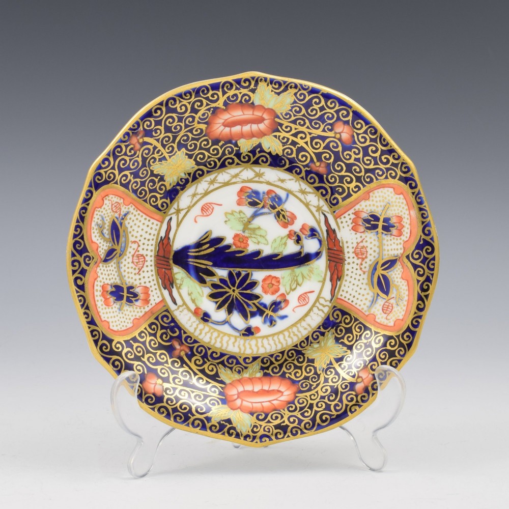 An Edwardian Royal Crown Derby porcelain coffee cup and matching saucer decorated in a rich cobalt blue, iron red, and gilt Imari pattern. View II