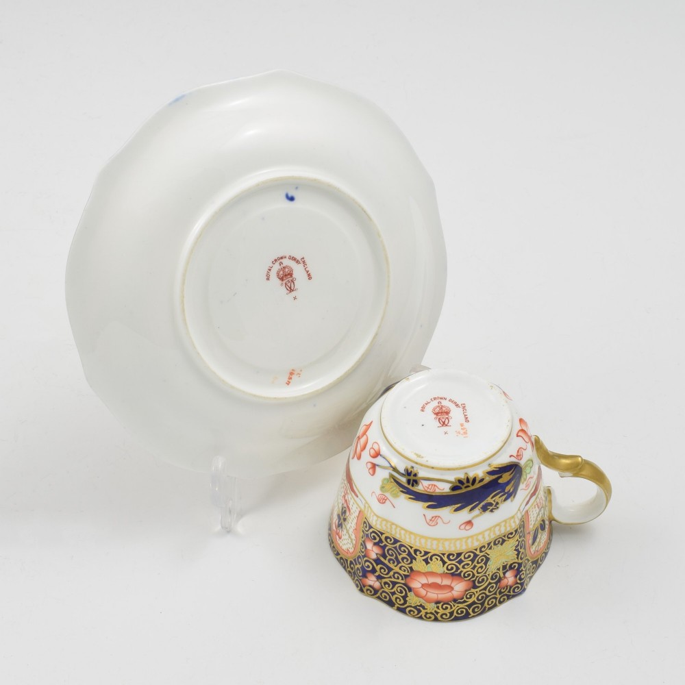 An Edwardian Royal Crown Derby porcelain coffee cup and matching saucer decorated in a rich cobalt blue, iron red, and gilt Imari pattern. View VII