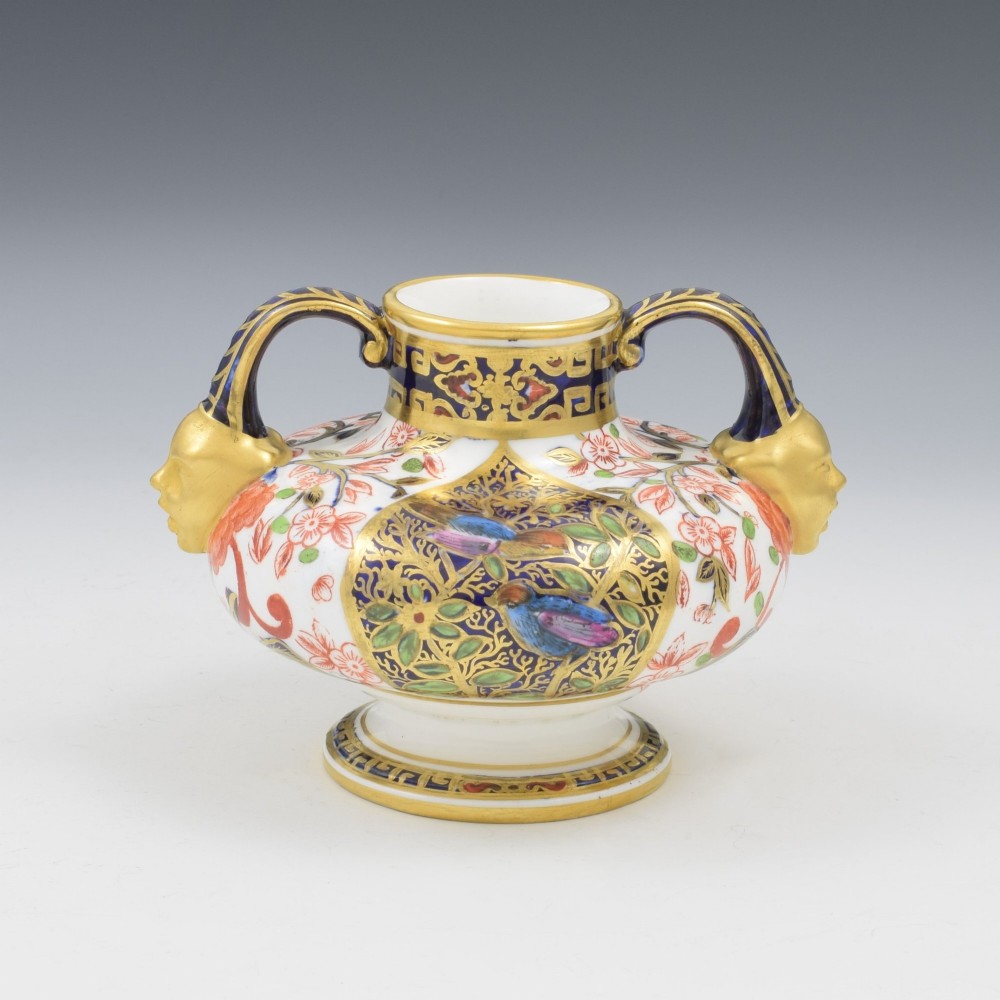 A Victorian Royal Crown Derby porcelain vase featuring twin gilded mask handles, intricate cobalt blue and gold panel decoration, and hand-painted floral motifs. View II