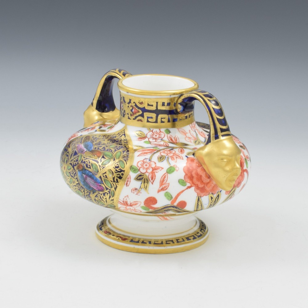 A Victorian Royal Crown Derby porcelain vase featuring twin gilded mask handles, intricate cobalt blue and gold panel decoration, and hand-painted floral motifs. View III