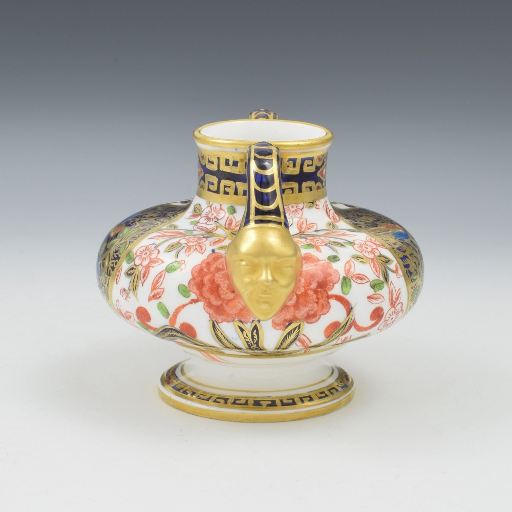 A Victorian Royal Crown Derby porcelain vase featuring twin gilded mask handles, intricate cobalt blue and gold panel decoration, and hand-painted floral motifs. View IV