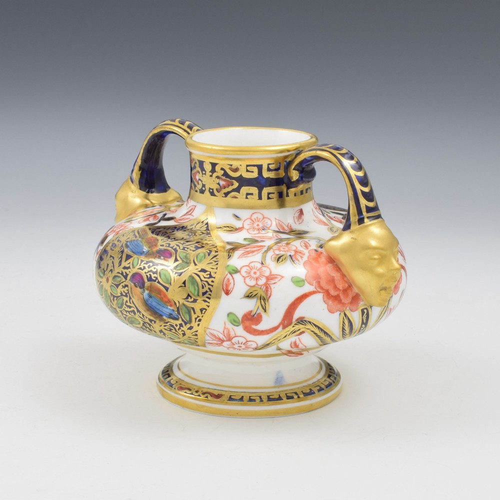 A Victorian Royal Crown Derby porcelain vase featuring twin gilded mask handles, intricate cobalt blue and gold panel decoration, and hand-painted floral motifs. View VII