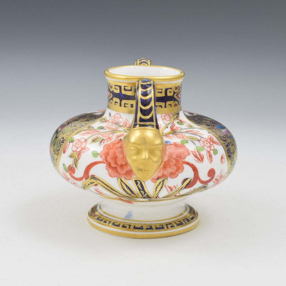 A Victorian Royal Crown Derby porcelain vase featuring twin gilded mask handles, intricate cobalt blue and gold panel decoration, and hand-painted floral motifs. View VIII
