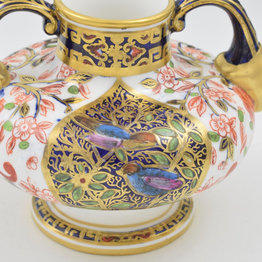 A Victorian Royal Crown Derby porcelain vase featuring twin gilded mask handles, intricate cobalt blue and gold panel decoration, and hand-painted floral motifs. View XI