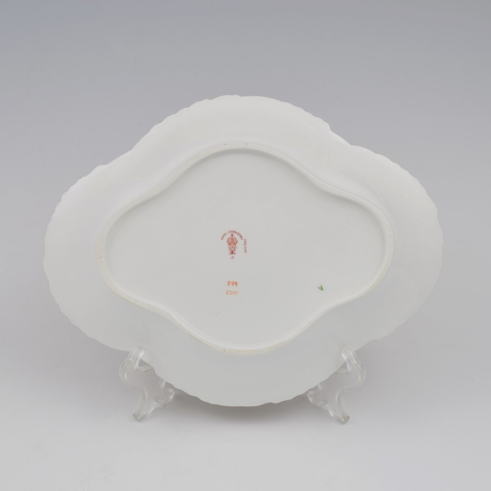 An oval antique Royal Crown Derby porcelain serving dish featuring intricate cobalt blue, coral red, and heavy gold leaf Imari pattern 6299 details with a lobed edge. View IX