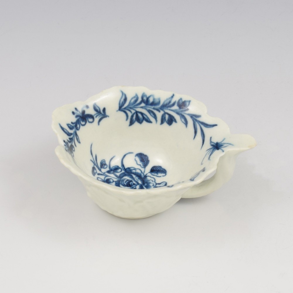 A leaf-shaped soft-paste porcelain butter boat decorated with an underglaze blue hand-painted rose motif and a floral running border. View III