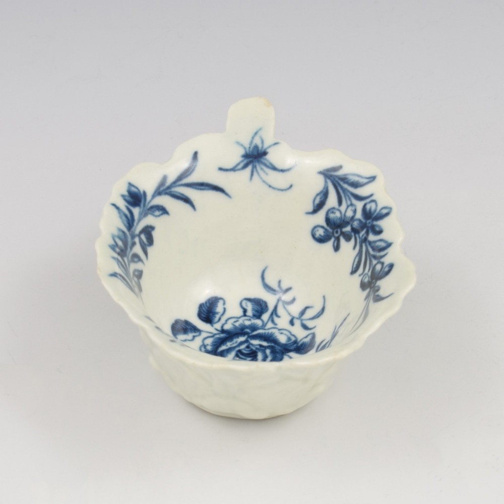 A leaf-shaped soft-paste porcelain butter boat decorated with an underglaze blue hand-painted rose motif and a floral running border. View IV