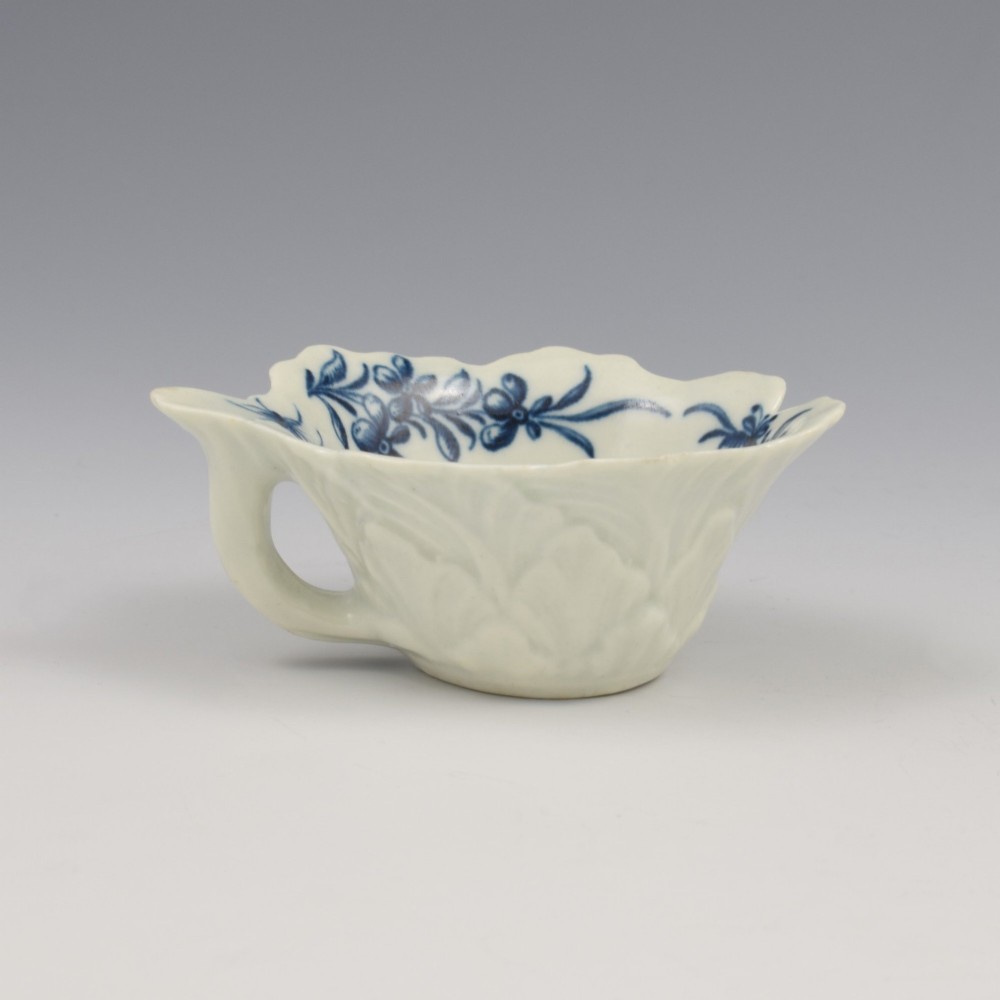 A leaf-shaped soft-paste porcelain butter boat decorated with an underglaze blue hand-painted rose motif and a floral running border. View V