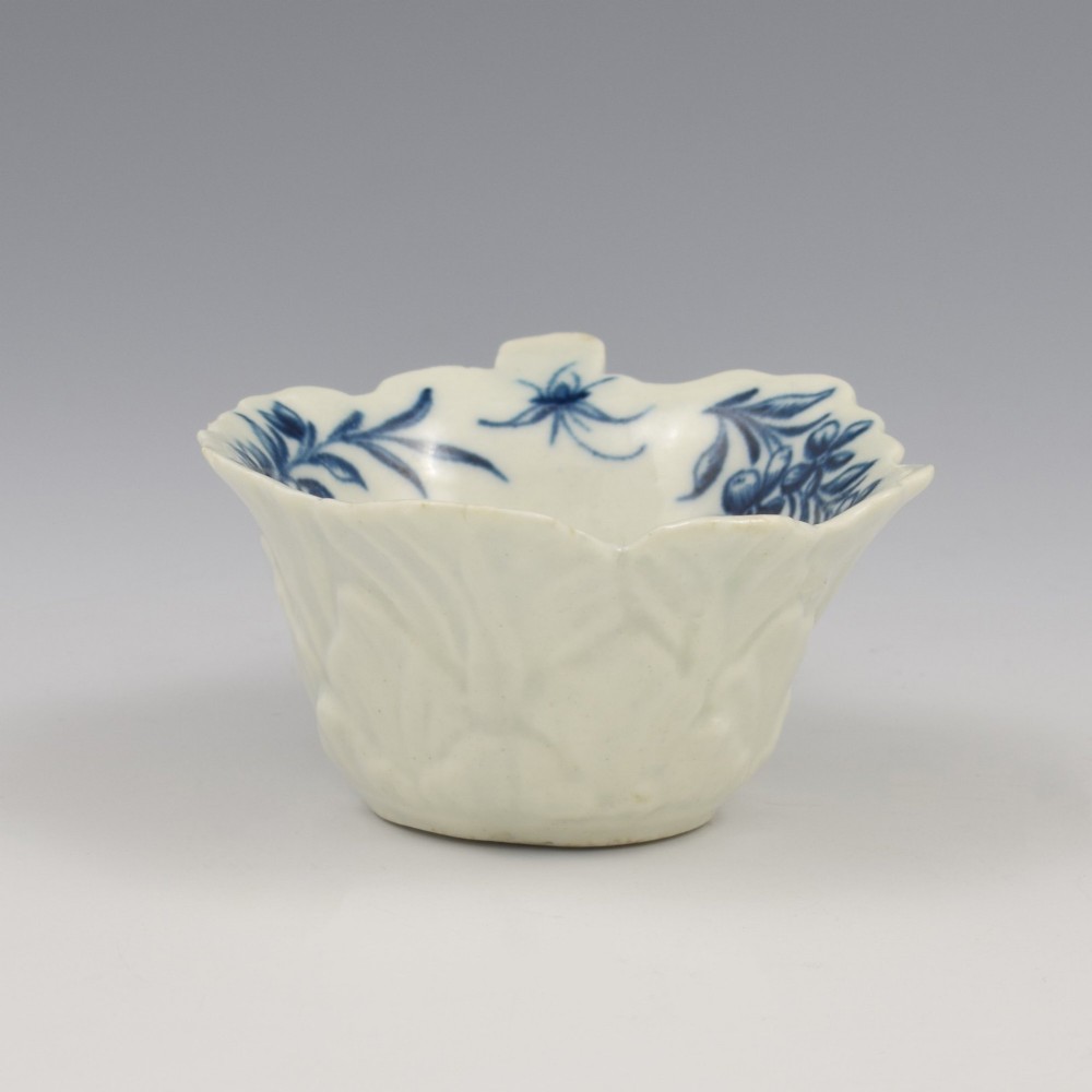 A leaf-shaped soft-paste porcelain butter boat decorated with an underglaze blue hand-painted rose motif and a floral running border. View VII