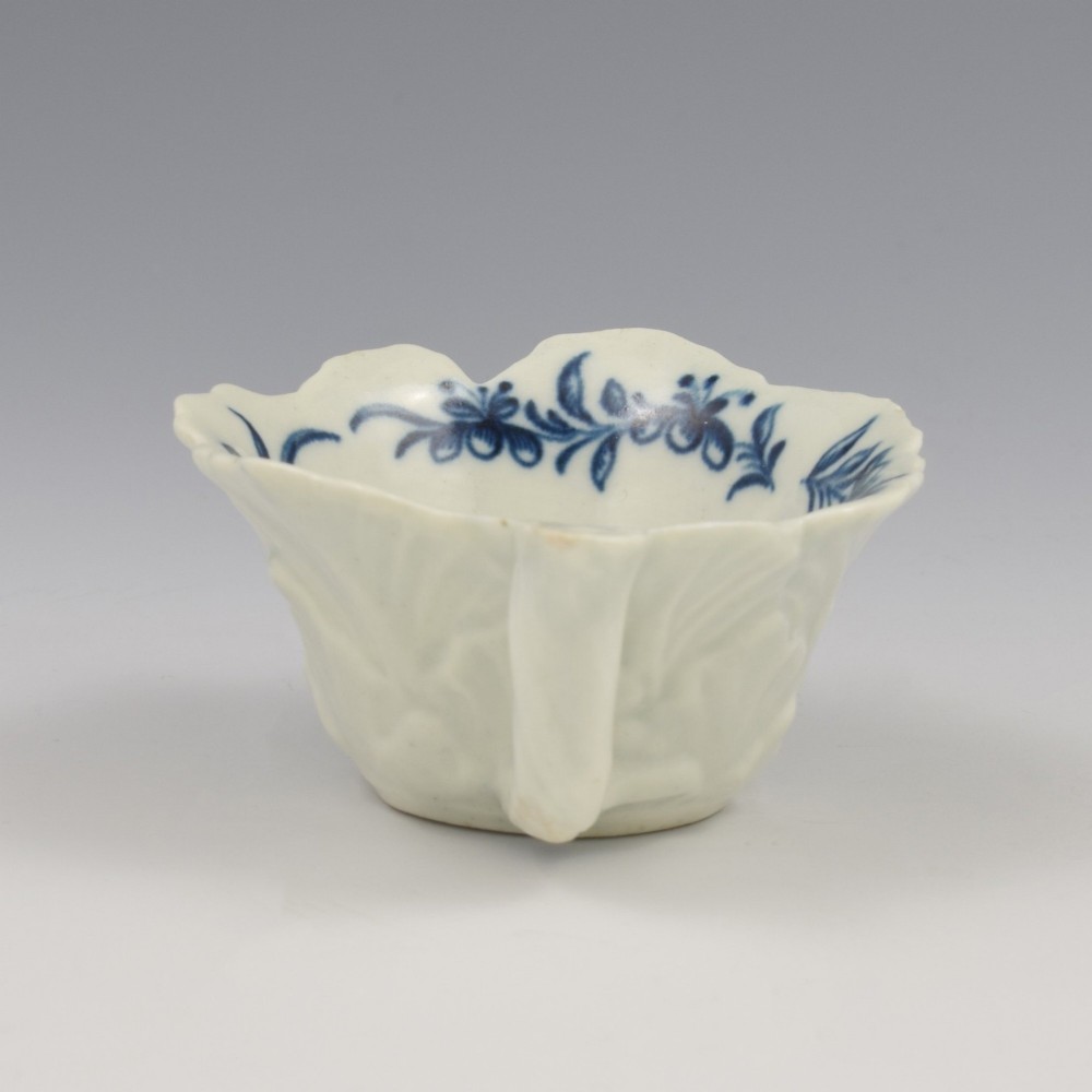 A leaf-shaped soft-paste porcelain butter boat decorated with an underglaze blue hand-painted rose motif and a floral running border. View IX