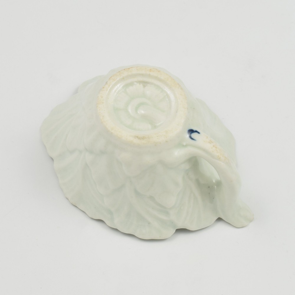A leaf-shaped soft-paste porcelain butter boat decorated with an underglaze blue hand-painted rose motif and a floral running border. View XI