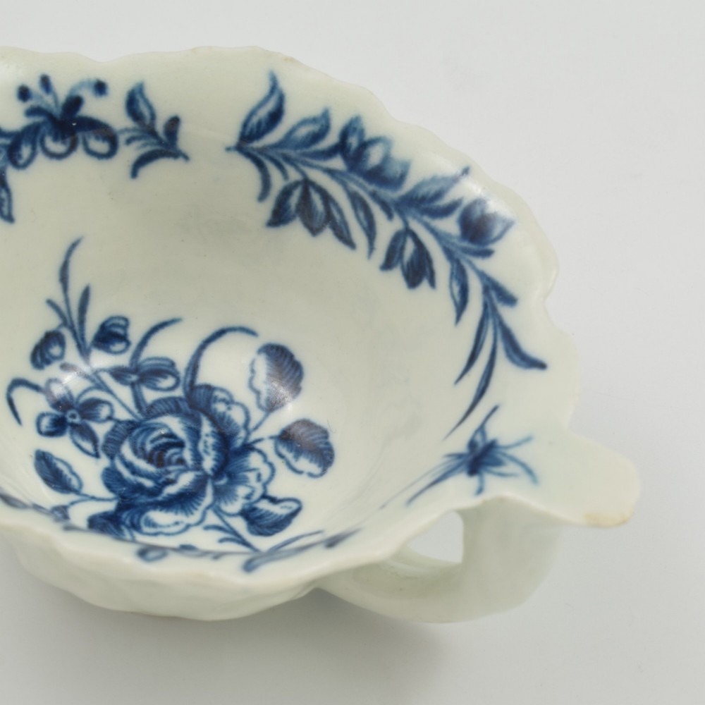 A leaf-shaped soft-paste porcelain butter boat decorated with an underglaze blue hand-painted rose motif and a floral running border. View XIII