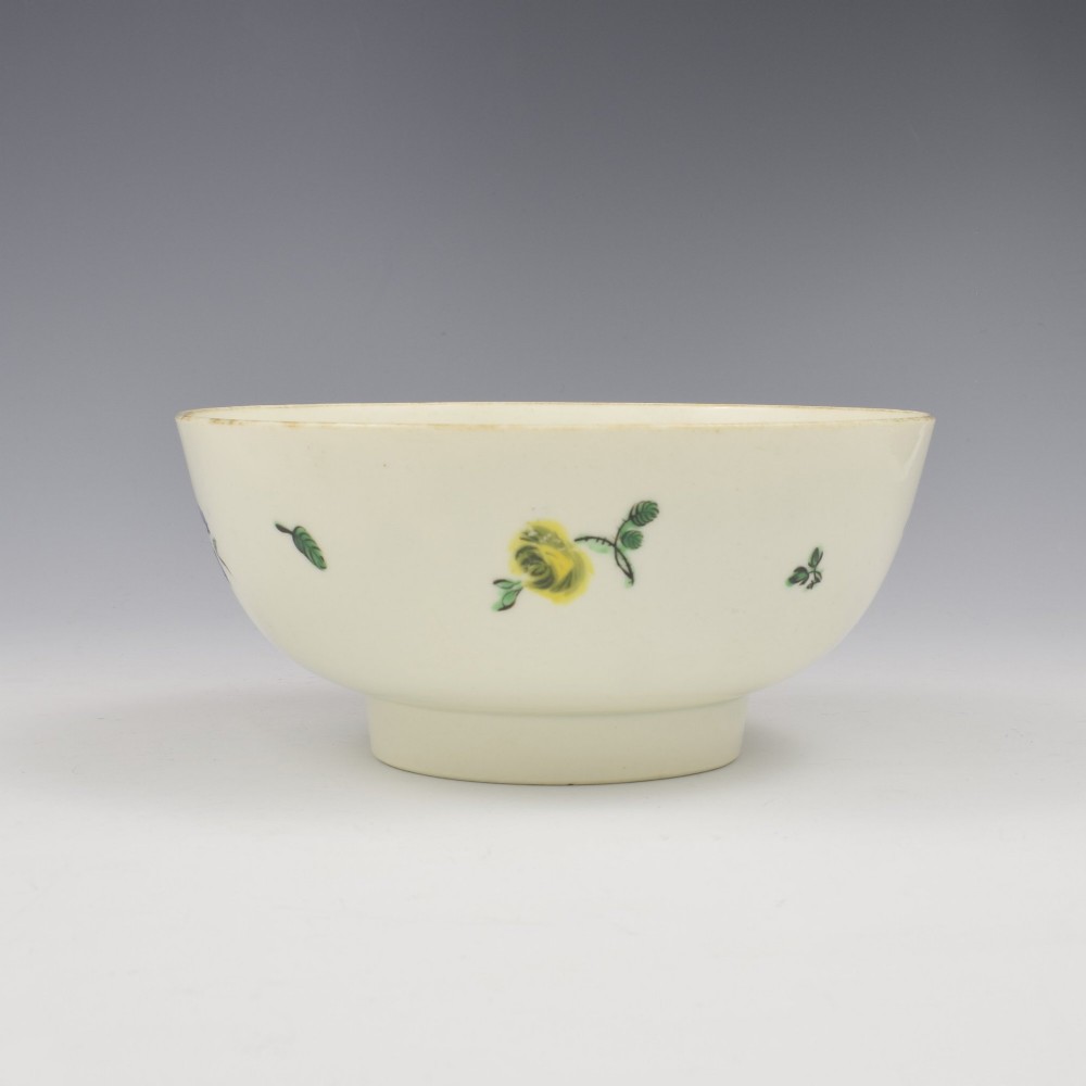 An 18th-century cream soft-paste porcelain slop bowl decorated with hand-painted floral motifs on a short foot rim. View III